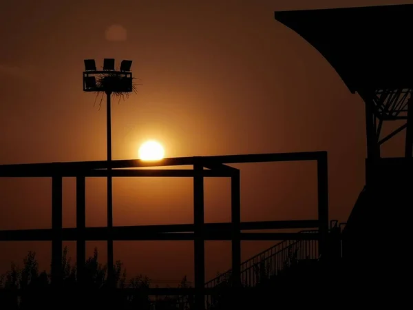 silhouette of a wooden house on the background of the sunset