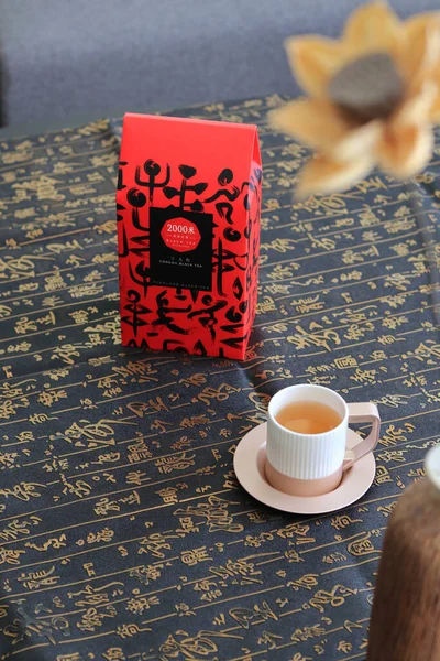 a cup of coffee and a book on a wooden background