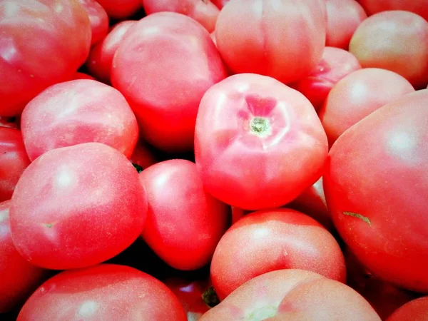 fresh red tomatoes on a market stall