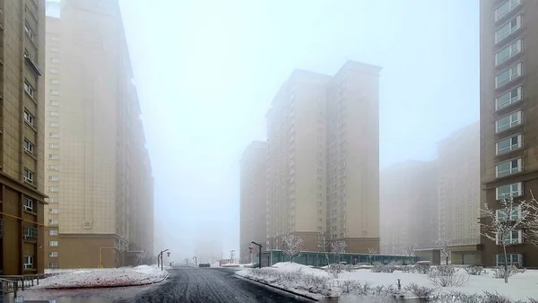 modern city buildings in the fog