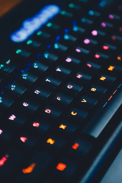 close up of a computer keyboard with a glowing led light
