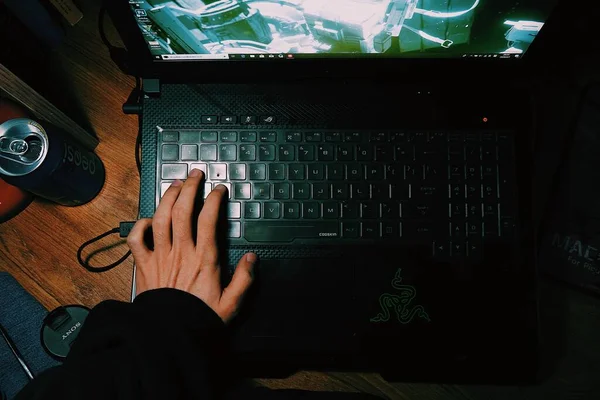 hacker using laptop and keyboard on the table