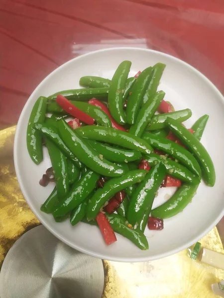 green beans with chili pepper and chilli on a plate