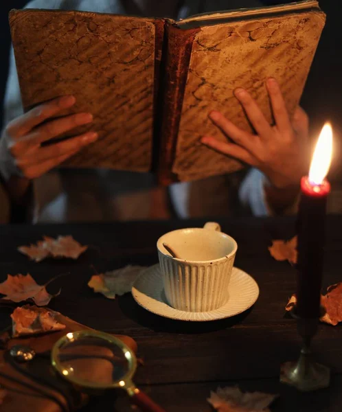 woman reading a book in the hands of a witch