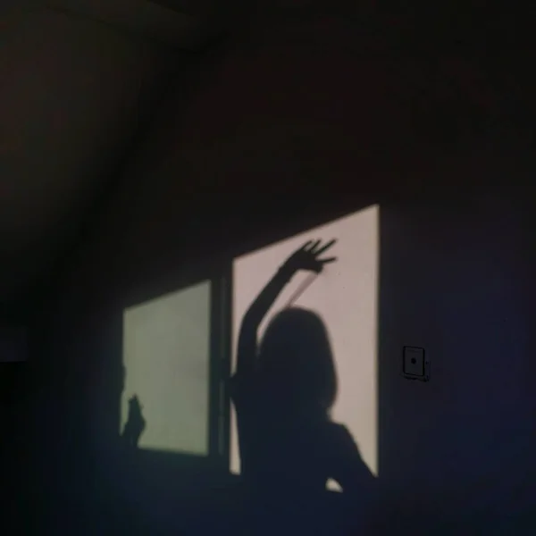 silhouette of a man in a black dress
