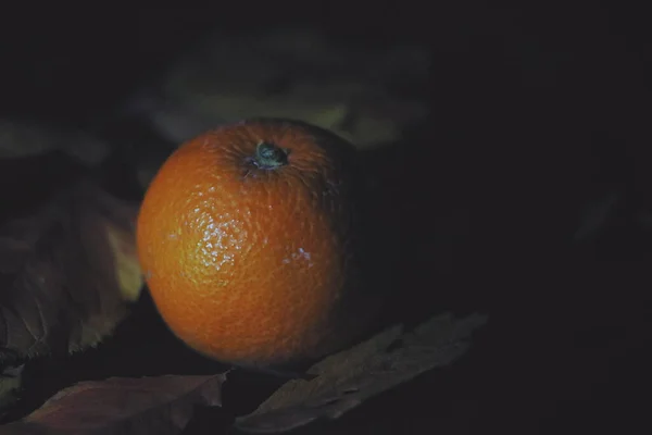 fresh ripe orange on black background