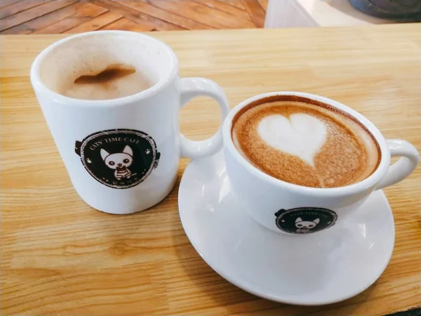 cup of coffee and a heart on a wooden background
