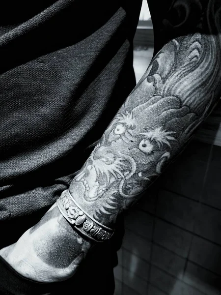 close up of a man\'s hand with a tattoo