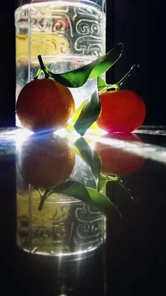 fresh red and green apples in a glass jar on a black background