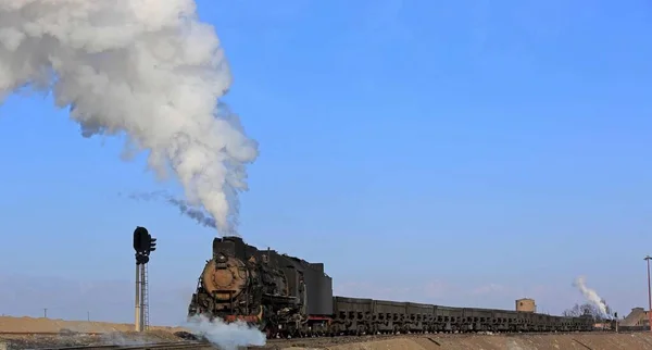 steam locomotive with smoke and coal