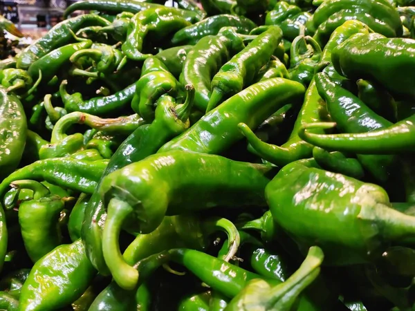 green and white peppers on a market stall
