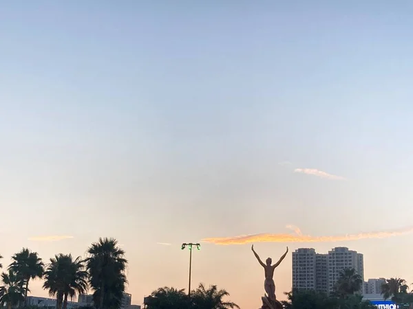 silhouette of a man with a backpack on the beach