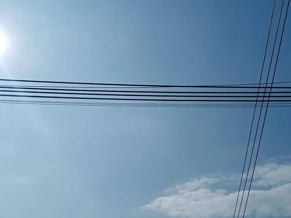 high voltage power lines and blue sky