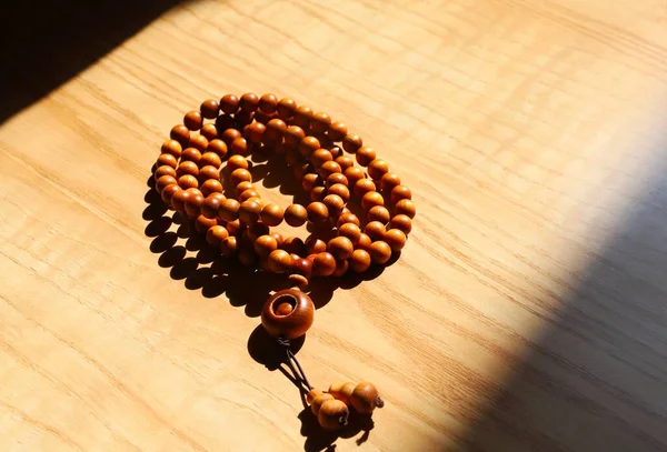 rosary beads on wooden background