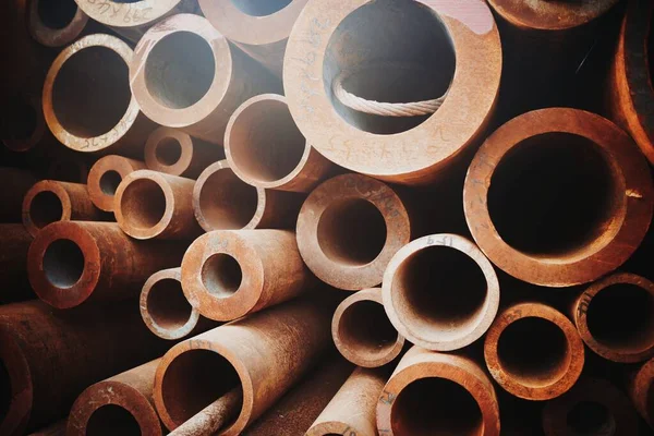 stack of metal pipes on a white background