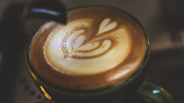 close up of a cup of coffee with a white background