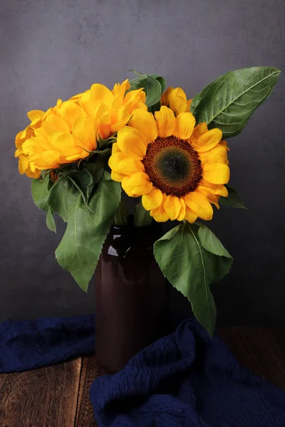 beautiful bouquet of sunflowers in a vase on a dark background