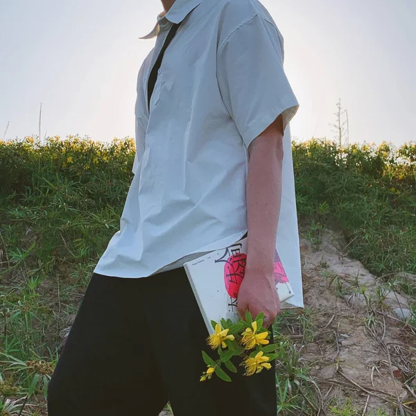 a man in a white shirt and a blue dress with a bouquet of flowers on a background of a