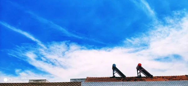 silhouette of a man with a roof of a building