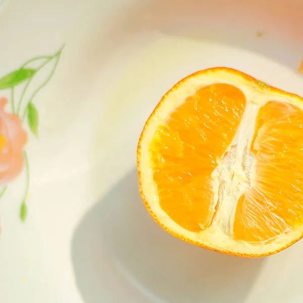 orange and yellow lemon on a white background