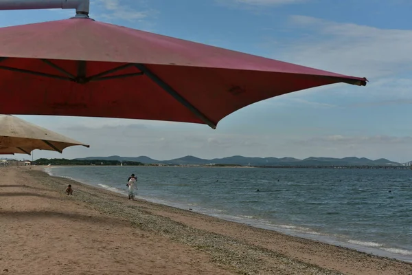 beach umbrellas and umbrella on the sea coast