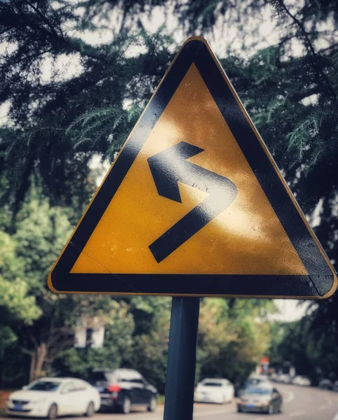 road sign with a warning symbol