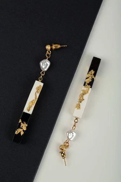 gold jewelry with a black and white background