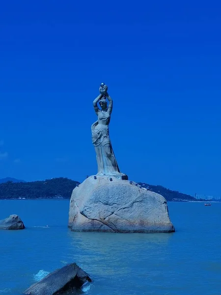 statue of a beautiful island of the virgin mary of the sea in the background