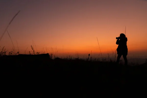 silhouette of a man with a sword on the background of the sunset