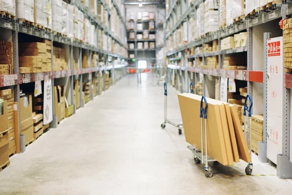 warehouse shelves with boxes in the background