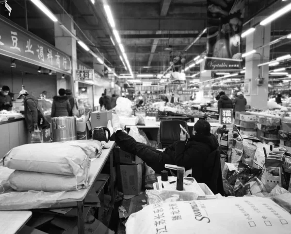 black and white image of a man in a shop