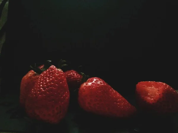 fresh red strawberries on a black background