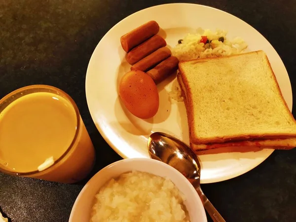 breakfast with toast, coffee, toasts, honey, orange juice and milk. top view