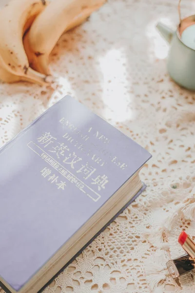 book with a cup of tea and a bible on a wooden table