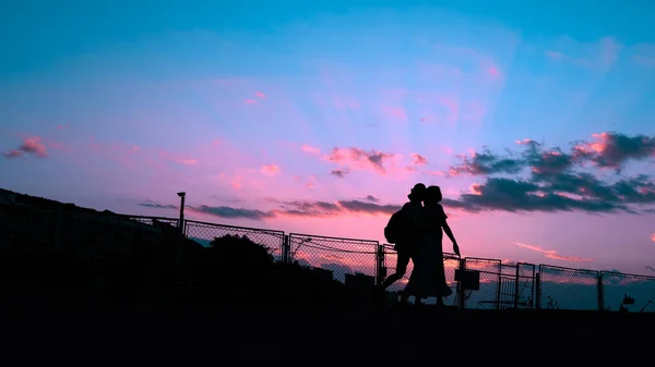 silhouette of a man and woman on the beach