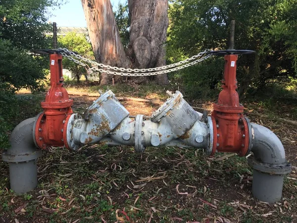 red water pipe with a large valve