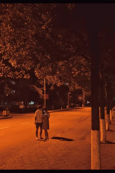 silhouette of a man and woman in the park