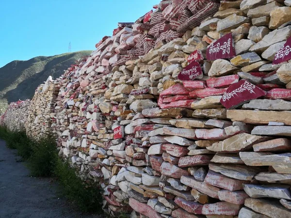 stone wall with red and blue stones