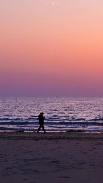 silhouette of a man and woman on the beach