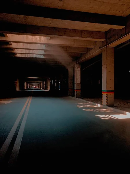 empty underground tunnel with dark concrete floor and lights background