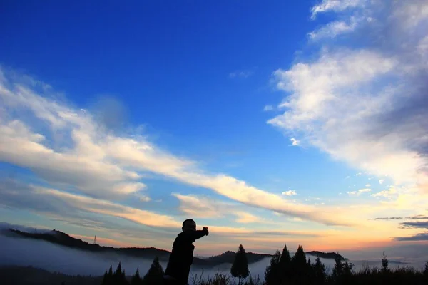 silhouette of a man and woman on the background of the mountain