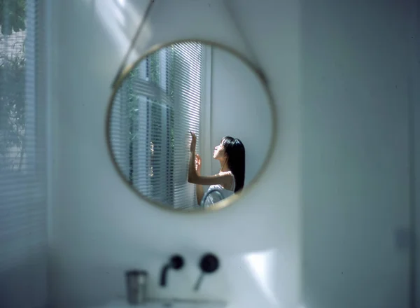 woman with a mirror in the bathroom