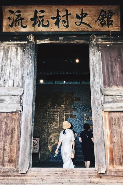 old wooden door with a woman in a hat