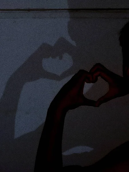 silhouette of a man with a heart on the background of the window