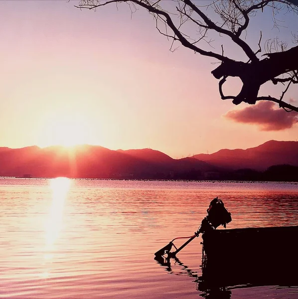 silhouette of a man on the lake