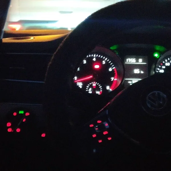 car dashboard with a red and white lights