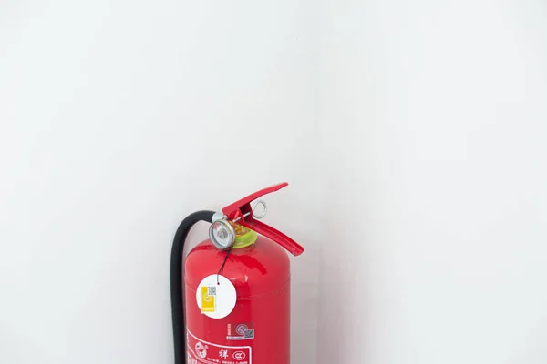 red fire extinguisher on white background