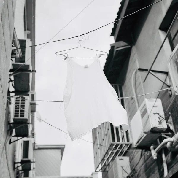 white and blue hanging laundry on the street