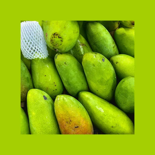 fresh green and white fruits on a background of a large box