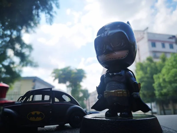 a boy in a helmet and a mask on a background of a car